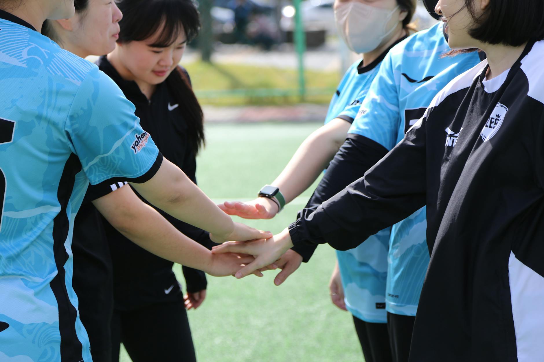 football team touching hands before match