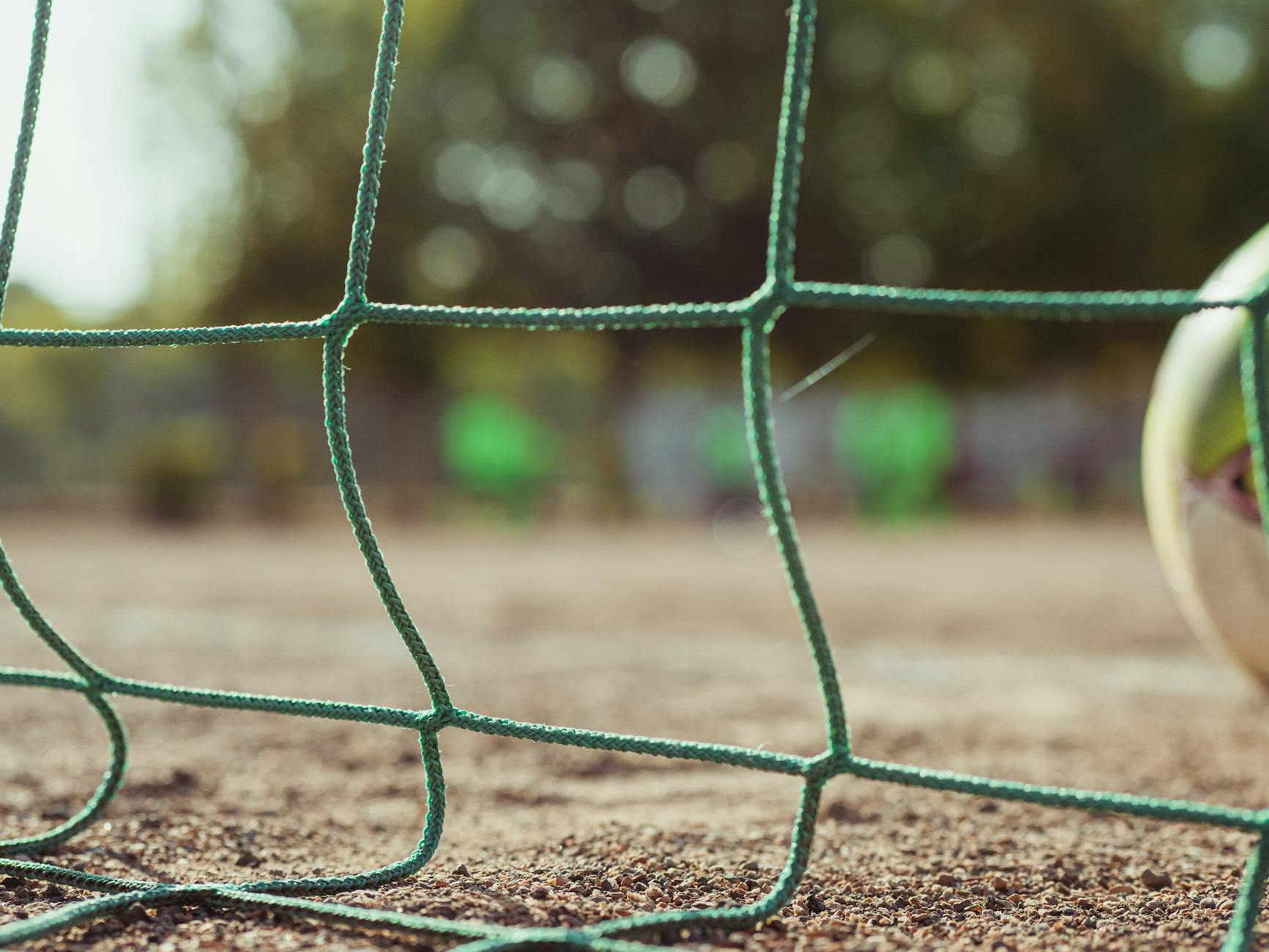 football goal on shabby stadium in summer