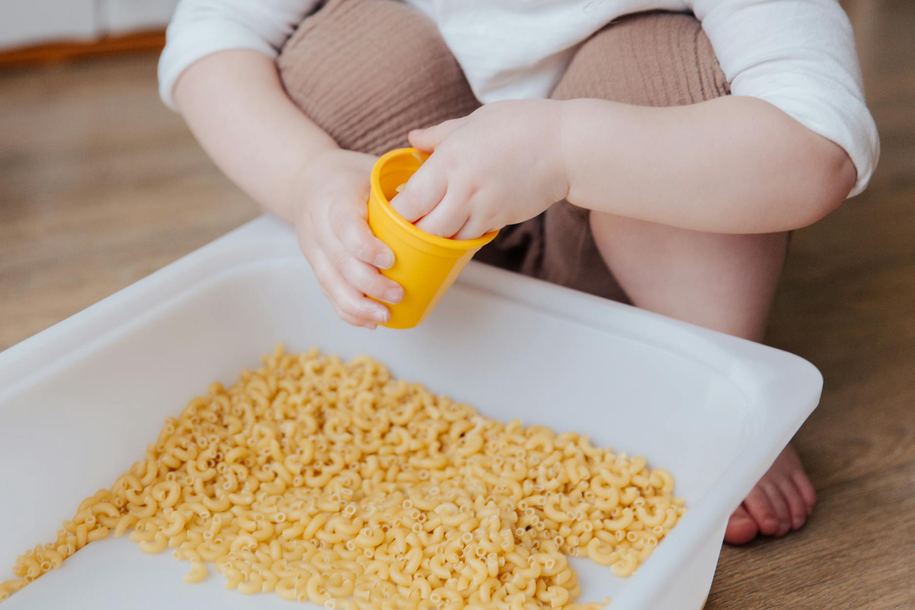 person holding yellow plastic container