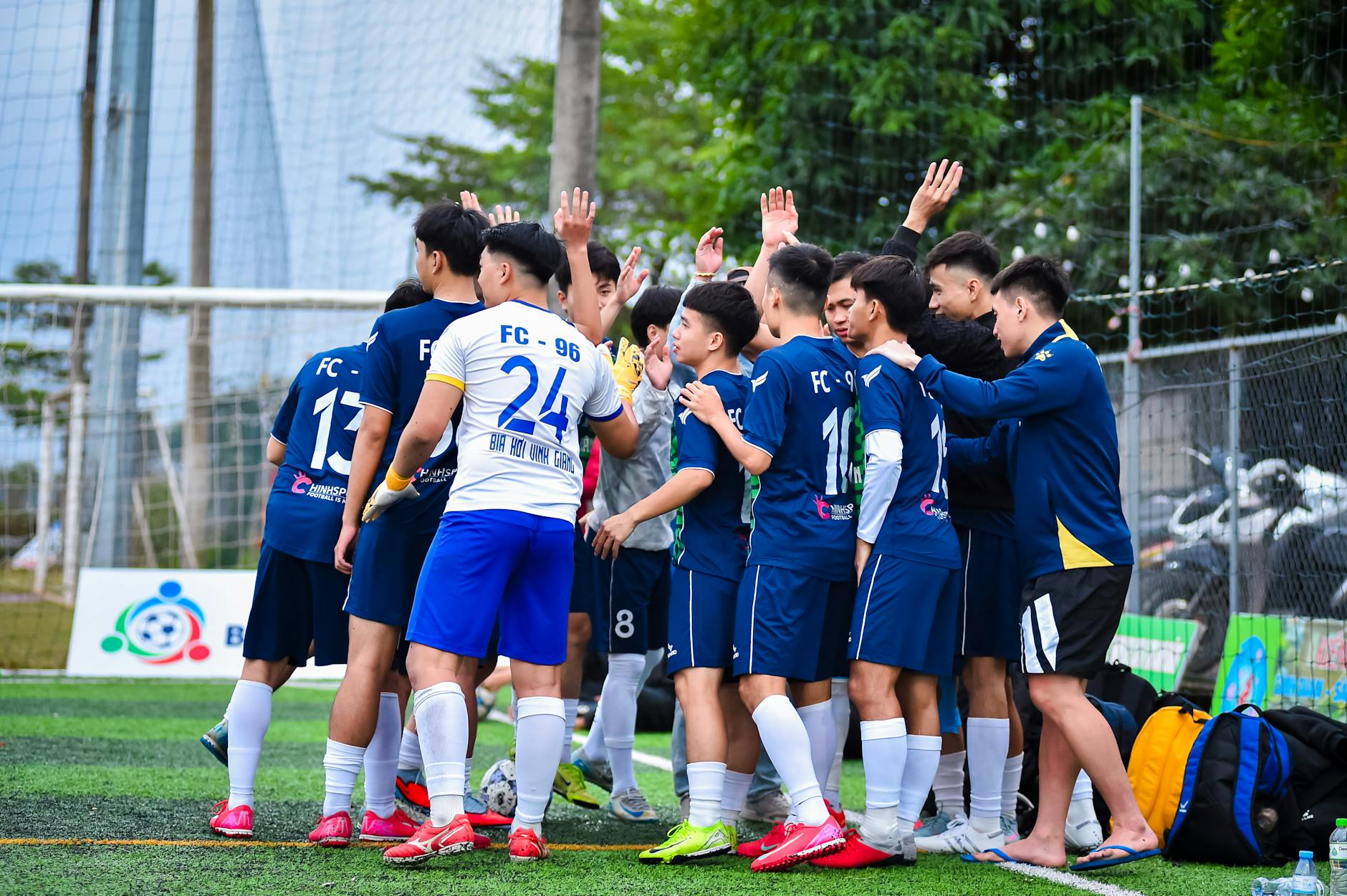 youth football team huddle on field in hanoi